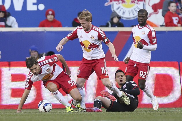 New York Red Bulls defender Damien Perrinelle (55) strips the ball from D.C. United forward Jairo Arrieta, lower right, as Red Bulls midfielder Dax McCarty (11) and defender Kemar Lawrence (92) follow behind during the second half of an MLS soccer game, Sunday, March 22, 2015, in Harrison, N.J. The Red Bulls won 2-0. (AP Photo/John Minchillo)