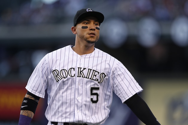 Colorado Rockies right fielder Carlos Gonzalez (5) heads tot he dugout after retiring the Atlanta Braves in the fifth inning of a baseball game Friday, July 10, 2015, in Denver. (AP Photo/David Zalubowski)