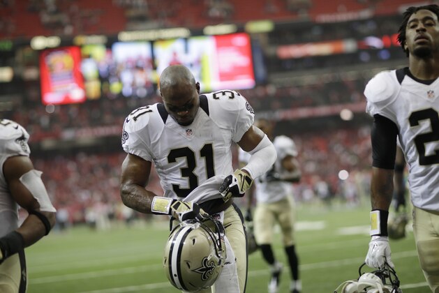 New Orleans Saints free safety Jairus Byrd (31) and others walk off the field after overtime of an NFL football game against the Atlanta Falcons, Sunday, Sept. 7, 2014, in Atlanta. The Atlanta Falcons won in overtime 37-34. (AP Photo/David Goldman)