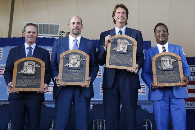 Newly-inducted National Baseball Hall of Famers Craig Biggio, John Smoltz, Randy Johnson and Pedro Martinez hold their plaques after an induction ceremony at the Clark Sports Center on Sunday, July 26, 2015, in Cooperstown, N.Y. (AP Photo/Mike Groll)