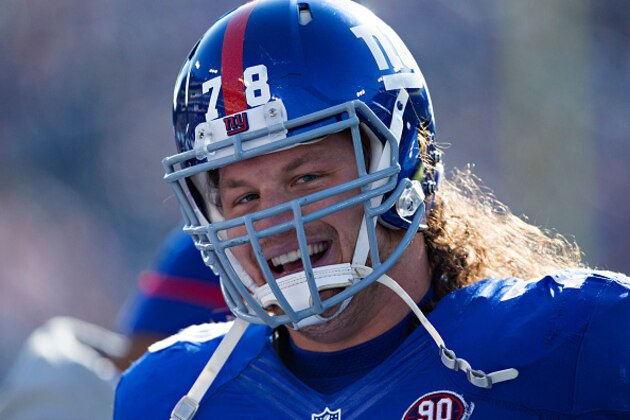 NASHVILLE, TN - DECEMBER 7:  Markus Kuhn #78 of the New York Giants smiles while running off the field after returning a fumble for a touchdown in the second quarter of a game against the Tennessee Titans at LP Field on December 7, 2014 in Nashville, Tennessee.  (Photo by Wesley Hitt/Getty Images)