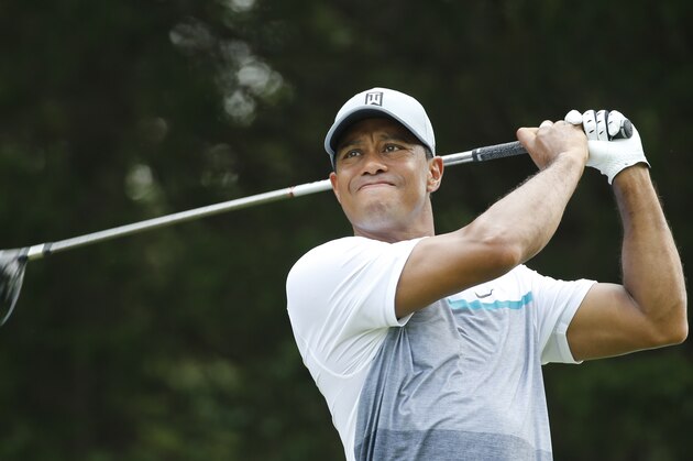 Tiger Woods watches his tee shot on the 18th hole during a practice round for the Quicken Loans National golt tournament at the Robert Trent Jones Golf Club in Gainesville, Va., Tuesday, July 28, 2015.  (AP Photo/Steve Helber)