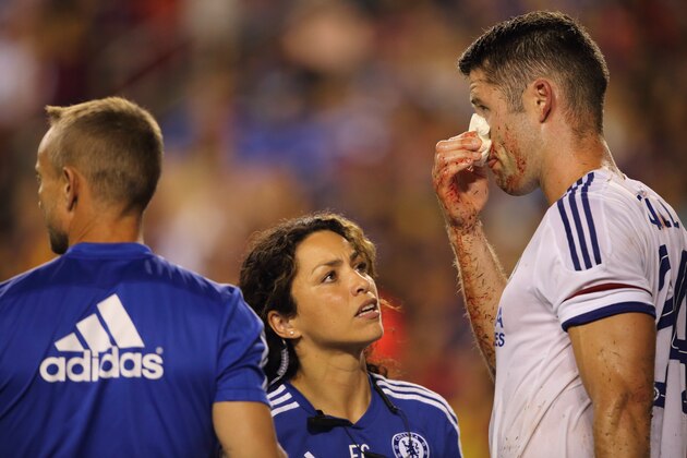 LANDOVER, MD - JULY 28:  Chelsea first-team doctor Eva Carneiro attends to Gary Cahill of Chelsea who suffered a bloody nose following scoring the goal which tied the game 2-2 during the International Champions Cup match between Barcelona and Chelsea at FedExField on July 28, 2015 in Landover, Maryland.  (Photo by Matthew Ashton - AMA/Getty Images)