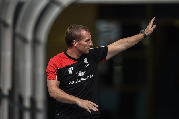 Liverpool's Northern Irish manager Brendan Rodgers gestures to Malaysian fans during a training session at the Bukit Jalil Stadium in Kuala Lumpur on July 23, 2015 on the eve of their friendly football match against Malaysia XI.     AFP PHOTO / MANAN VATSYAYANA        (Photo credit should read MANAN VATSYAYANA/AFP/Getty Images)