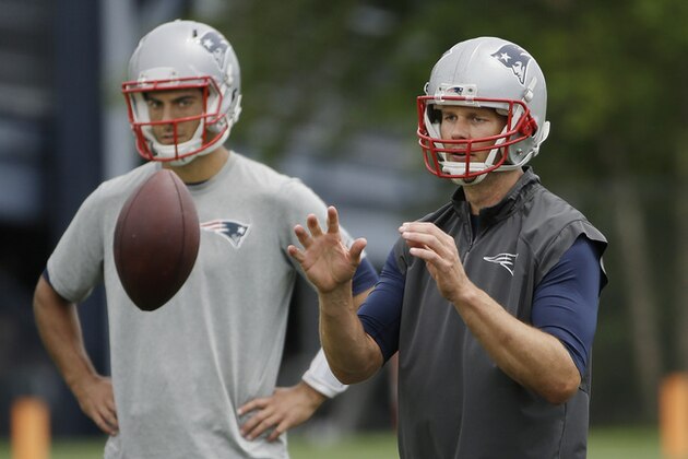 New England Patriots quarterback Tom Brady takes a snap as backup quarterback Jimmy Garoppolo looks on during an NFL football minicamp, Wednesday, June 17, 2015, in Foxborough, Mass. (AP Photo/Stephan Savoia)