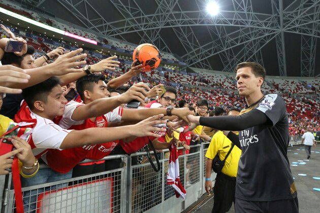 SINGAPORE - JULY 15:  Wojciech Szczesny of Arsenal takes photographs with fans after the Barclays Asia Trophy match between Arsenal and Singapore Select XI at National Stadium on July 15, 2015 in Singapore.  (Photo by Lionel Ng/Getty Images)