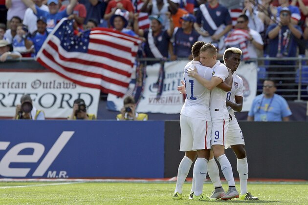 United States' Aron Johannsson (9) celebrates with teammates Timmy Chandler, left, and Gyasi Zardes after scoring a goal during the first half of a CONCACAF Gold Cup soccer quarterfinal match against Cuba, Saturday, July 18, 2015, in Baltimore. The United States won 6-0. (AP Photo/Patrick Semansky)
