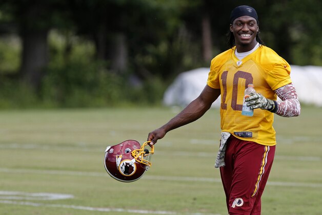 Jun 16, 2015; Ashburn, VA, USA; Washington Redskins quarterback Robert Griffin III (10) walks off the field after day one of Redskins Minicamp at Redskins Park. Mandatory Credit: Geoff Burke-USA TODAY Sports