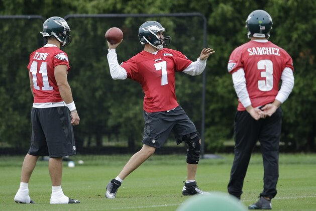 Philadelphia Eagles quarterback Sam Bradford (7) throws a pass as quarterbacks Tim Tebow (11) and Mark Sanchez look on during organized team activities at the team's NFL football training facility, Tuesday, June 2, 2015, in Philadelphia. (AP Photo/Matt Rourke)