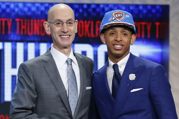 Cameron Payne, right, poses for photos with NBA Commissioner Adam Silver after being selected 14th overall by the Oklahoma City Thunder during the NBA basketball draft, Thursday, June 25, 2015, in New York. (AP Photo/Kathy Willens)