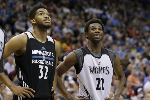 Minnesota Timberwolves forward Andrew Wiggins (22) and center Karl-Anthony Towns (32) watch a free-throw during an NBA basketball scrimmage in Minneapolis, Wednesday, July 8, 2015.  (AP Photo/Ann Heisenfelt)