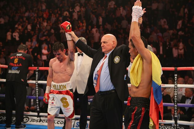 MANCHESTER, ENGLAND - JULY 18: Anthony Crolla and Darleys Perez have their arms raised as the result is announced as a draw during their WBA World Lightweight Championship contest at the Manchester Arena on July 18, 2015 in Manchester, England. (Photo by Dave Thompson/Getty Images)