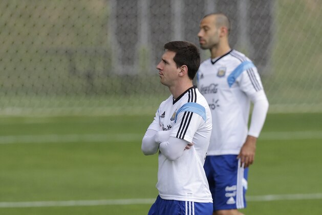 Argentina's Lionel Messi, left, and Javier Mascherano walk during a training session in Vespesiano, near Belo Horizonte, Brazil, Thursday, July 10, 2014. On Sunday, Argentina faces Germany for the World Cup final soccer match in Rio de Janeiro. (AP Photo/Victor R. Caivano)