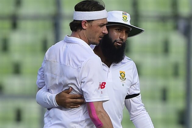 South Africa captain Hashim Amla (R) congratulates teammate Dale Steyn (L) after the dismissal of unseen Bangladesh batsman Mohammad Shahid during the first day of the second cricket Test match between Bangladesh and South Africa at The Sher-e-Bangla National Cricket Stadium in Dhaka on July 30, 2015. AFP PHOTO/ Munir uz ZAMAN        (Photo credit should read MUNIR UZ ZAMAN/AFP/Getty Images)