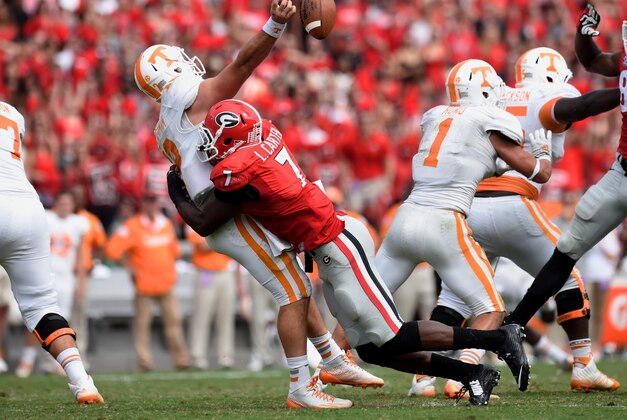 Sep 27, 2014; Athens, GA, USA; Georgia Bulldogs linebacker Lorenzo Carter (7) hits Tennessee Volunteers quarterback Nathan Peterman (12) as he releases the ball during the second half at Sanford Stadium. Georgia defeated Tennessee 35-32. Mandatory Credit: Dale Zanine-USA TODAY Sports