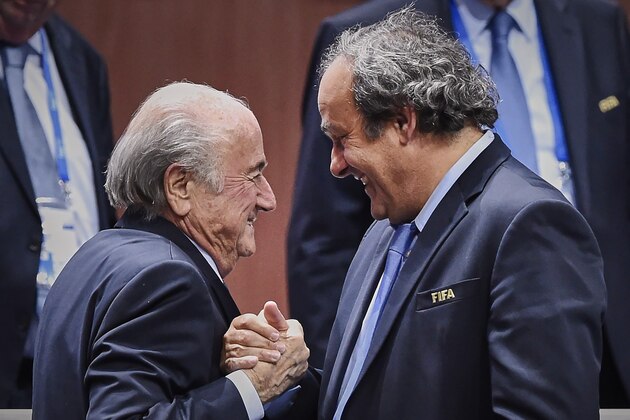 FIFA President Sepp Blatter (Foreground-L) shakes hands with UEFA president Michel Platini after being re-elected following a vote to decide on the FIFA presidency in Zurich on May 29, 2015. Sepp Blatter won the FIFA presidency for a fifth time after his challenger Prince Ali bin al Hussein withdrew just before a scheduled second round. AFP PHOTO / MICHAEL BUHOLZER        (Photo credit should read MICHAEL BUHOLZER/AFP/Getty Images)
