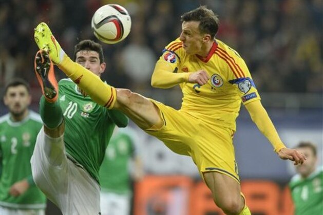 CAPTION CORRECTION, CORRECTS TO NORTHERN IRELAND - Romania's Vlad Chiriches, right, and Northern Ireland's Kyle Lafferty, left, challenge for the ball during a Group F, Euro 2016 qualifying soccer match between Romania and Northern Ireland, at the National Arena stadium in Bucharest, Romania, Friday, Nov. 14, 2014. (AP Photo/Octav Ganea, Mediafax) ROMANIA OUT CAPTION CORRECTION, CORRECTS TO NORTHERN IRELAND - Romania's Vlad Chiriches, right, and Northern Ireland's Kyle Lafferty, left, challenge for the ball during a Group F, Euro 2016 qualifying soccer match between Romania and Northern Ireland, at the National Arena stadium in Bucharest, Romania, Friday, Nov. 14, 2014. (AP Photo/Octav Ganea, Mediafax) ROMANIA OUT