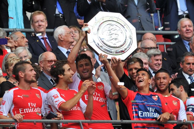 QUALITY REPEAT
Arsenal's French striker Olivier Giroud (CL) and Arsenal's Chilean midfielder Alexis Sanchez (CR) raise the Community Shield trophy after Arsenal won the FA Community Shield football match between Arsenal and Manchester City at Wembley Stadium in north London on August 10, 2014. AFP PHOTO / GLYN KIRK -- NOT FOR MARKETING OR ADVERTISING USE / RESTRICTED TO EDITORIAL USE        (Photo credit should read GLYN KIRK/AFP/Getty Images)