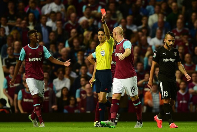 LONDON, ENGLAND - JULY 30:  James Collins of West Ham (2R) is being shown a red card by Referee, Adrien Jaccottet during the UEFA Europa League third qualifying round match between West Ham United and Astra Giurgiu at the Boleyn Ground on July 30, 2015 in London, England.  (Photo by Dan Mullan/Getty Images)