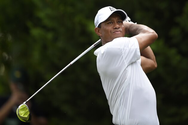 Tiger Woods watches his tee shot on the 3rd tee during the first round of the Quicken Loans National Golf tournament at the Robert Trent Jones Golf Club in Gainesville, Va., Thursday, July 30, 2015. (AP Photo/Nick Wass)