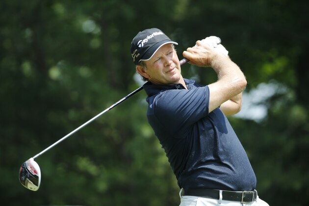 Retief Goosen, of South Africa, watches his tee shot on the 15th tee during the first round of the Quicken Loans National golf tournament at the Robert Trent Jones Golf Club in Gainesville, Va., Thursday, July 30, 2015.  (AP Photo/Steve Helber)