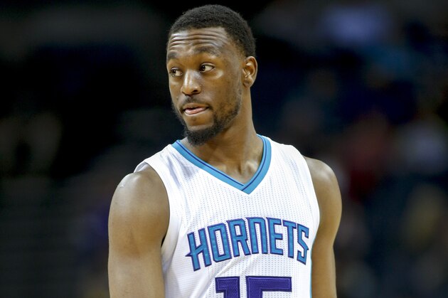 Charlotte Hornets guard Kemba Walker   walks across the court during a break in  the action against the Sacramento  in an NBA basketball game Wednesday, March 11, 2015 in Charlotte, N.C. Sacramento won 113-106. (AP Photo/Nell Redmond)