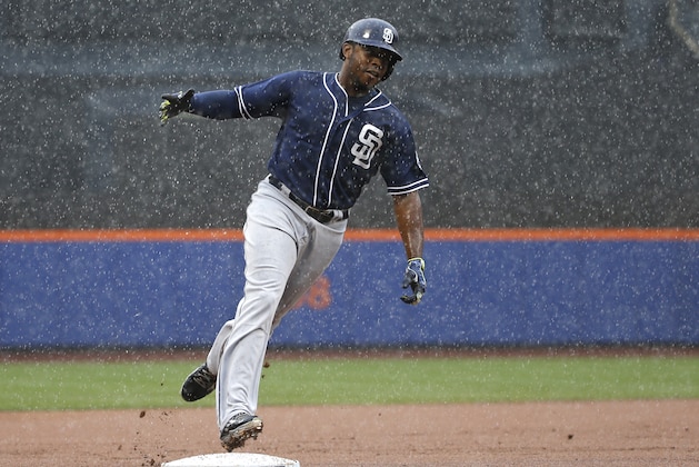 San Diego Padres Justin Upton celebrates running towards home plate after hitting a ninth-inning, three-run, home run off New York Mets relief pitcher Jeurys Familia in a rain-delayed baseball game in New York, Thursday, July 30, 2015. (AP Photo/Kathy Willens)