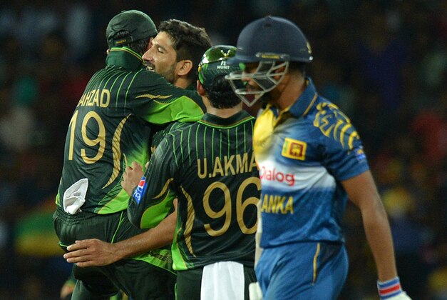 Pakistan cricketer Sohail Tanvir (2L) and teammates celebrate after dismissing Sri Lankan batsman Kithuruwan Vithanage during the first Twenty20 International cricket match between Sri Lanka and Pakistan at The R Premadasa International Cricket Stadium in Colombo on July 30, 2015. AFP PHOTO / ISHARA S KODIKARA        (Photo credit should read Ishara S.KODIKARA/AFP/Getty Images)