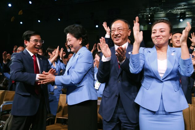 China's Vice Premier Liu Yandong, second left, is greeted by Wang Anshun, left, Beijing mayor and president of the Beijing 2022 Olympic Winter Games Bid, as other members of the delegation from Beijing 2022 Winter Olympics candidate city react after Beijing was elected to host the 2022 Olympic Winter Games at IOC meeting in Kuala Lumpur, Malaysia, Friday, July 31, 2015. (AP Photo/Vincent Thian, Pool)