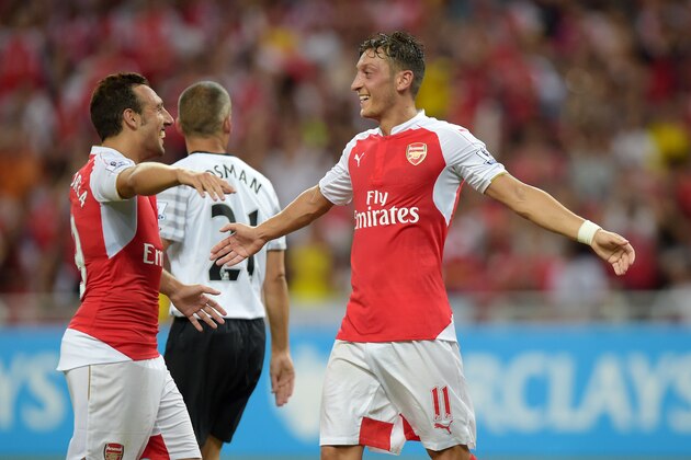Arsenal's Mesut Ozil, right, celebrates his goal against Everton during their Barclays Asia Trophy soccer final in Singapore, Saturday, July 18, 2015. (AP Photo/Joseph Nair)