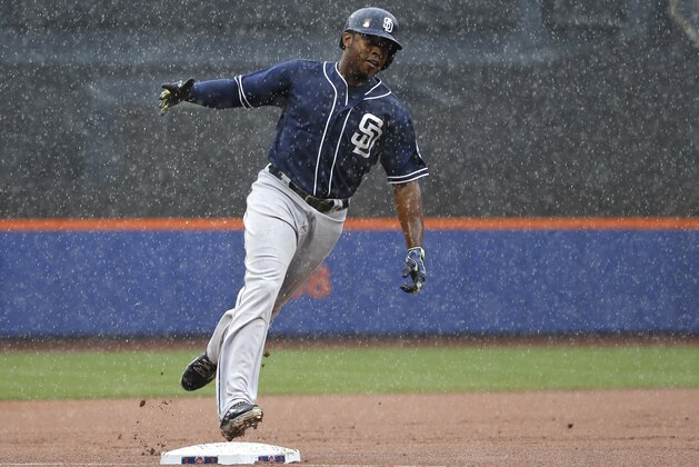 San Diego Padres Justin Upton celebrates running towards home plate after hitting a ninth-inning, three-run, home run off New York Mets relief pitcher Jeurys Familia in a rain-delayed baseball game in New York, Thursday, July 30, 2015. (AP Photo/Kathy Willens)