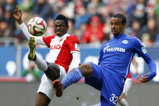 Augsburg's Abdul Rahman Baba from Ghana, left, and Schalke's Joel Matip from Cameroon challenge for the ball during the German first division Bundesliga soccer match between FC Augsburg and FC Schalke 04 in the SGL Arena in Augsburg, Germany, on Sunday, April 5, 2015. (AP Photo/Matthias Schrader)