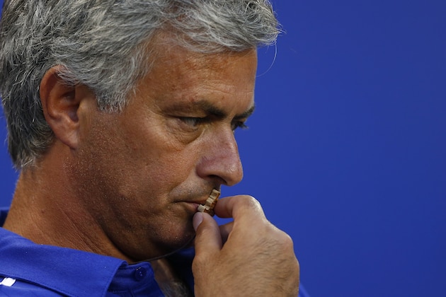Chelsea FC manager Jose Mourinho kisses a cross before the start of a match against the New York Red Bulls in the International Champions Cup in Harrison N.J., Wednesday, July 22, 2015. Chelsea lost 4-2. (AP Photo/Rich Schultz)