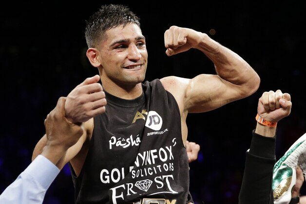 Amir Khan celebrates after defeating Devon Alexander in their welterweight bout Saturday, Dec. 13, 2014, in Las Vegas. (AP Photo/John Locher)