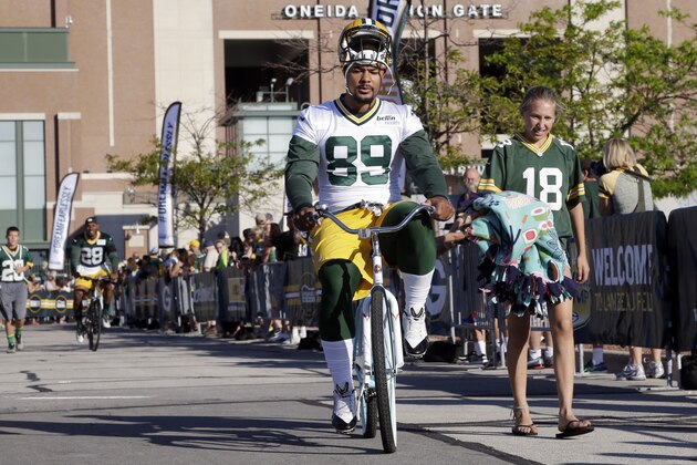 Green Bay Packers’ Richard Rodgers rides a bike to NFL football training camp Thursday, July 30, 2015, in Green Bay, Wis. (AP Photo/Morry Gash)