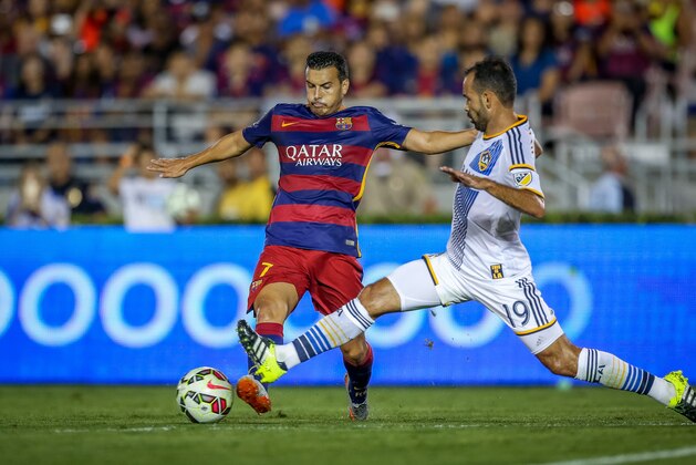 IMAGE DISTRIBUTED FOR INTERNATIONAL CHAMPIONS CUP - FC Barcelona's Pedro Rodriguez tries to keep ahead of LA Galaxy's AJ De La Garza during Tuesday's soccer match at the Rose Bowl in Pasadena, Calif., Tuesday, July 21, 2015. (Doug Benc/AP Images for International Champions Cup)