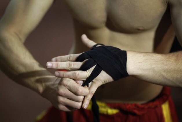 In this photo taken Tuesday, Dec. 29, 2009, Israeli kick boxer Daniel Tovali wraps his hands ahead of a fight during Israel's Kick Boxing championship in the Arab village of Kfar Yasif, northern Israel. The third Israeli Kick Boxing Championship was held Tuesday in the northern community of Kfar Yasif. (AP Photo/Ariel Schalit)