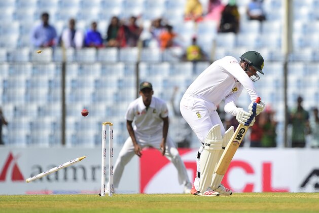South African cricketer Quinton de Kock is bowled out by Bangladesh cricketer Mustafizur Rahman during the first day of the first cricket Test match between Bangladesh and South Africa at the Zahur Ahmed Chowdhury Stadium in Chittagong on July 21, 2015. AFP PHOTO/ Munir uz ZAMAN        (Photo credit should read MUNIR UZ ZAMAN/AFP/Getty Images)