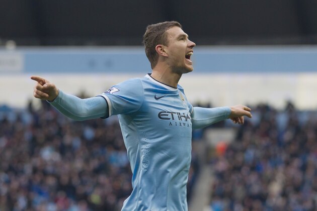 Manchester City's Edin Dzeko celebrates after scoring against Cardiff City during their English Premier League soccer match at the Etihad Stadium, Manchester, England, Saturday Jan 18, 2014. (AP Photo/Jon Super)