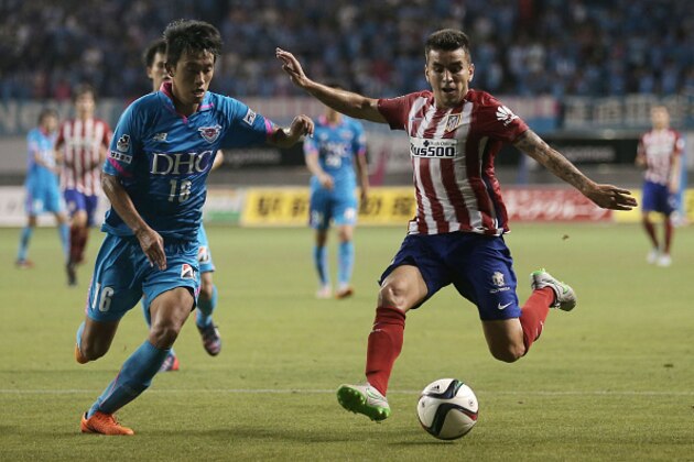 TOSU, JAPAN - AUGUST 01: Angel Correa #16 of Atletico Madrid takes a shot at goal under pressure from Choi Sung Keun #16 of Sagan Tosu F.C. during the friendly match between Atletico Madrid and Sagan Tosu F.C. at Tosu Stadium on August 1, 2015 in Tosu, Japan.  (Photo by Chris McGrath/Getty Images)