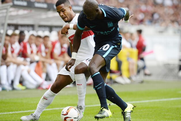 Stuttgart's midfielder Daniel Didavi (L) and Manchester's French defender Eliaquim Mangala vie for the ball during the friendly football match between VfB Stuttgart and Manchester City in Stuttgart, southern Germany, on August 1, 2015. AFP PHOTO / THOMAS KIENZLE        (Photo credit should read THOMAS KIENZLE/AFP/Getty Images)
