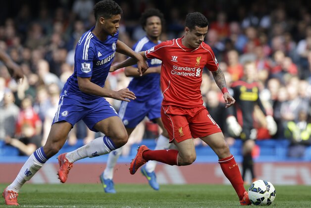 Chelsea’s Ruben Loftus-Cheek, left, vies for the ball with Liverpool's Philippe Coutinho during their English Premier League soccer match between Chelsea and Liverpool at Stamford Bridge stadium in London, Sunday, May 10,  2015. (AP Photo/Matt Dunham)