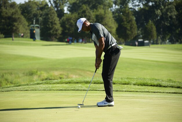 Jul 31, 2015; Gainesville, VA, USA; Tiger Woods putts on the 15th hole in the second round of the Quicken Loans National golf tournament at Robert Trent Jones Golf Club. Mandatory Credit: Rafael Suanes-USA TODAY Sports