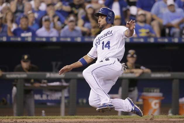 Kansas City Royals' Omar Infante slides home during the seventh inning of a baseball game against the Pittsburgh Pirates Wednesday, July 22, 2015, in Kansas City, Mo. (AP Photo/Charlie Riedel)