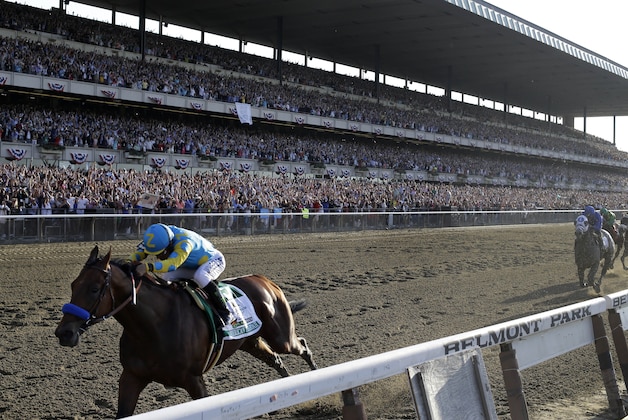 American Pharoah and jockey Victor Espinoza cross the finish line to win the 147th running of the Belmont Stakes horse race at Belmont Park, Saturday, June 6, 2015, in Elmont, N.Y. American Pharoah is the first horse to win the Triple Crown since Affirmed won it in 1978. (AP Photo/Julio Cortez)