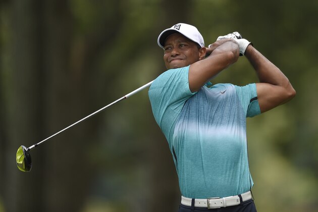 Tiger Woods watches his tee shot on the fifth tee during the third round of the Quicken Loans National golf tournament at the Robert Trent Jones Golf Club in Gainesville, Va., Saturday, Aug. 1, 2015. (AP Photo/Nick Wass)