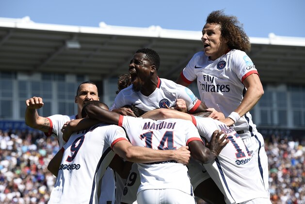 Paris Saint-Germain's Uruguayan forward Edinson Cavani is congratulated by teammates during the French Trophy of Champions football match against Lyon at Saputo stadium in Montreal on August 1, 2015.   AFP PHOTO/ FRANCK FIFE        (Photo credit should read FRANCK FIFE/AFP/Getty Images)