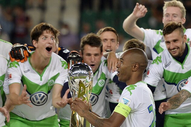 Wolfsburg captain Naldo from Brazil holds the trophy after winning the German Supercup final soccer match between VfL Wolfsburg and Bayern Munich in Wolfsburg, Germany, Saturday, Aug. 1, 2015.  Wolfsburg defeated Bayern with 6-5 after penalties. (AP Photo/Martin Meissner)