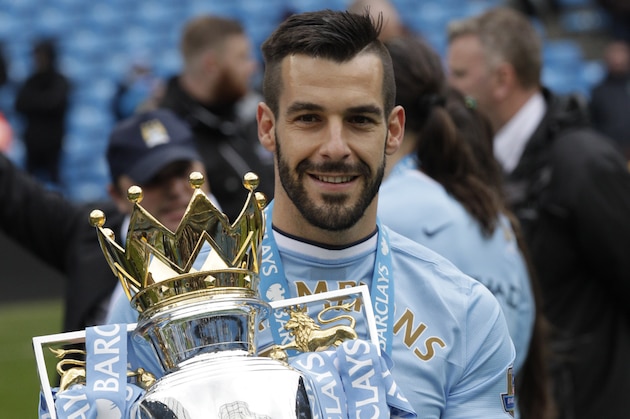 Manchester City's Alvaro Negredo poses for photographers with the trophy after the English Premier League soccer match between Manchester City and West Ham at the Etihad Stadium in Manchester, England, Sunday May 11, 2014.  Manchester City won the Premier League for the second time in three seasons on Sunday, completing its campaign with a comfortable 2-0 victory over West Ham that lacked any of the drama of its previous title.  (AP Photo/Jon Super)
