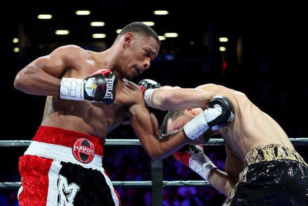 Daniel Jacobs, left, in action against Sergio Mora during their WBA Middleweight title fight at the Barclays Center in Brooklyn, on Saturday, August 1, 2015. (AP Photo/Gregory Payan)